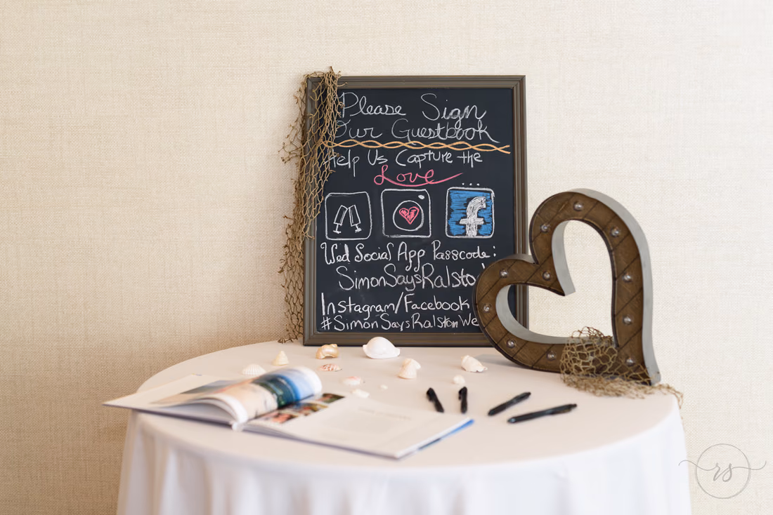 Chalkboard 'Please sign our guestbook' sign by the guestbook table at Hilton Myrtle Beach Resort at Kingston Resorts