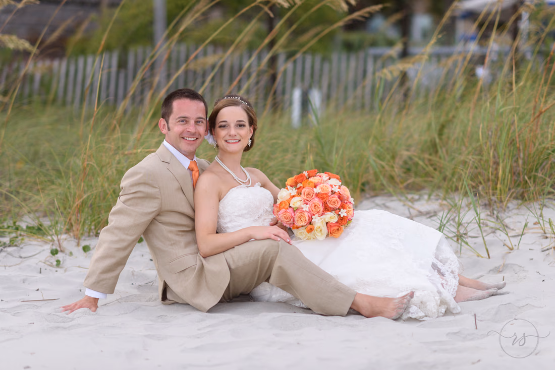 Wedding couple sitting together in front of the sea oats - Hilton Myrtle Beach Resort at Kingston Resorts