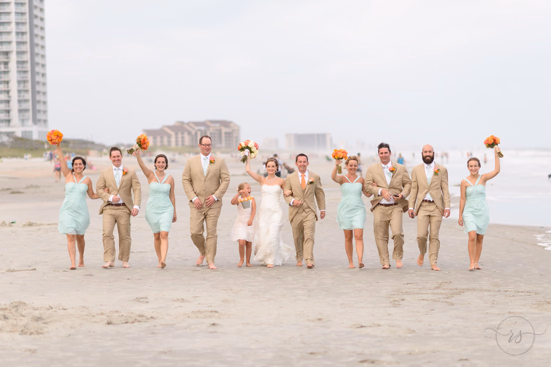 Wedding party walking together down a crowded beach - Hilton Myrtle Beach Resort at Kingston Resorts