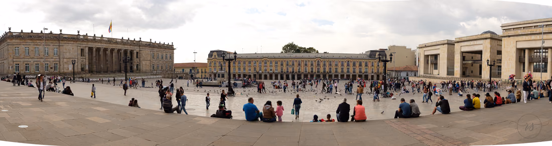 Panorama of the main square in La Candelaria, Bogota, with crowds in front of historic government buildings
