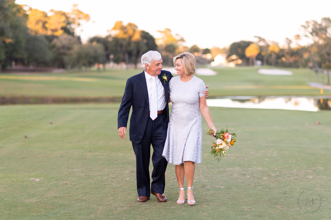 Bride and groom walking together down the golf course - Dunes Golf and Beach Club - Myrtle Beach