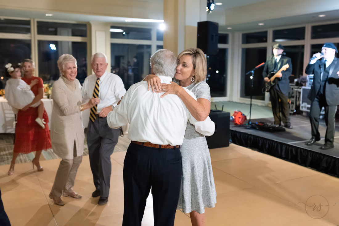 Bride and groom dance near the band as guests join in at the Dunes Golf and Beach Club in Myrtle Beach