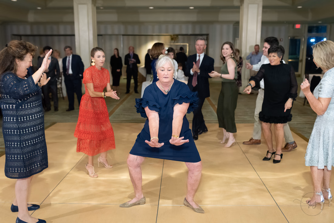 Guests dance in a circle as a woman drops low in the middle at the Dunes Golf and Beach Club in Myrtle Beach