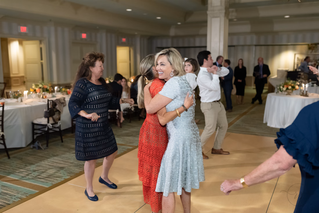 Bride hugs a guest on the dance floor at the Dunes Golf and Beach Club in Myrtle Beach