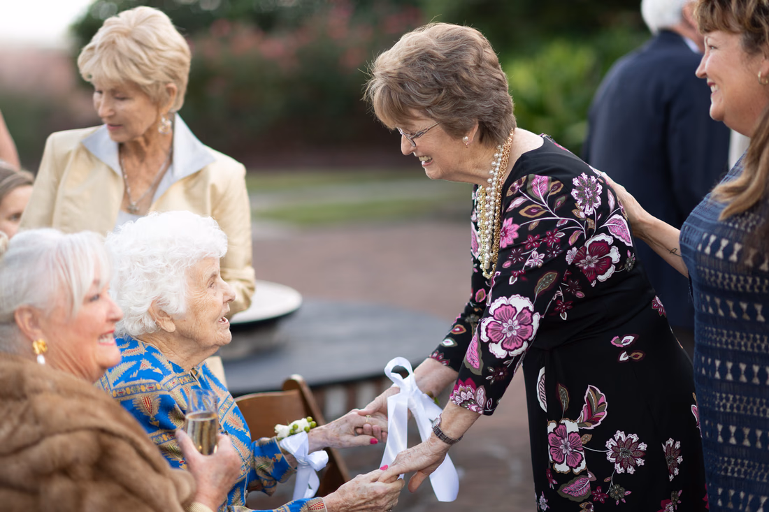 Groom's mother, in her 90s, greets guests before the ceremony at the Dunes Golf and Beach Club in Myrtle Beach