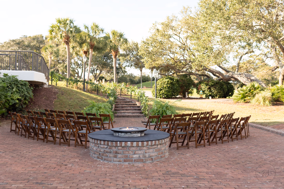 Wedding chairs set up around the fire pit on the patio at the Dunes Golf and Beach Club in Myrtle Beach