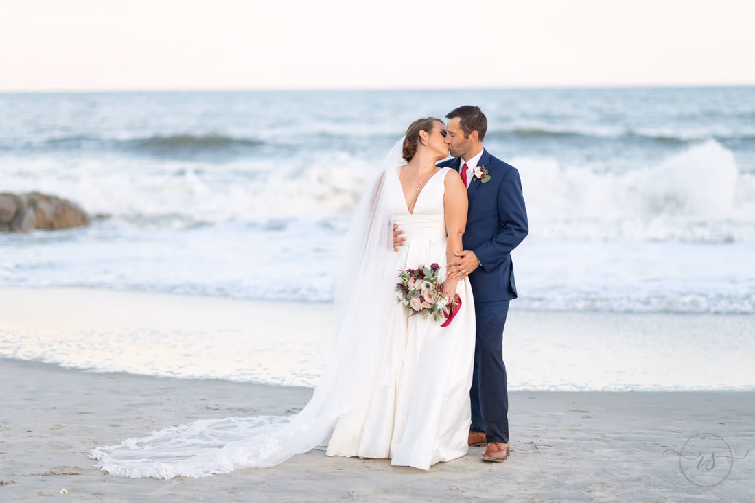 Bride and groom kissing in front of the waves - Pelican Inn - Pawleys Island