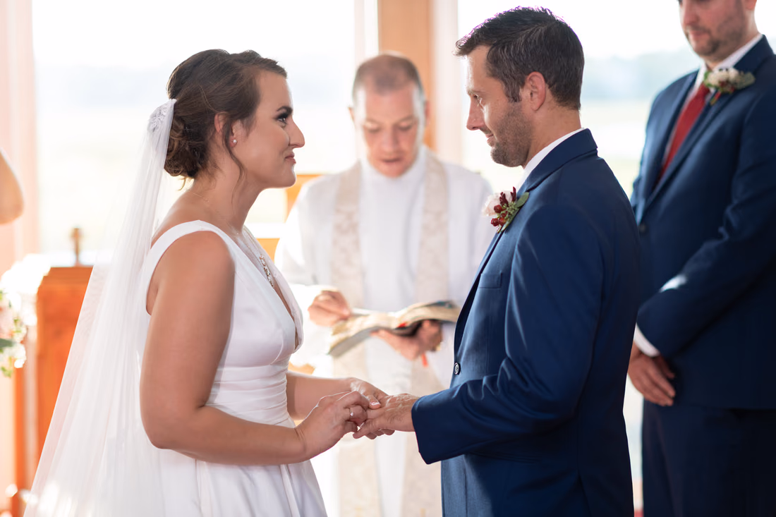 Bride putting ring on the groom - Pawleys Island Chapel