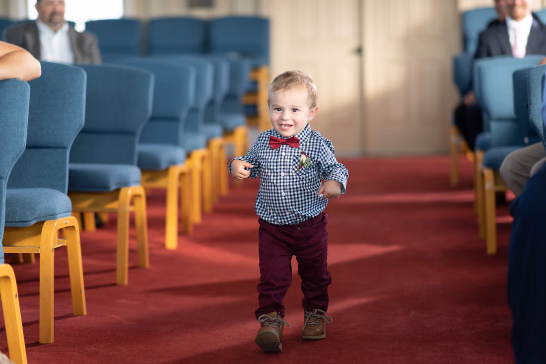 Happy ring bearer walking down the aisle - Pawleys Island Chapel