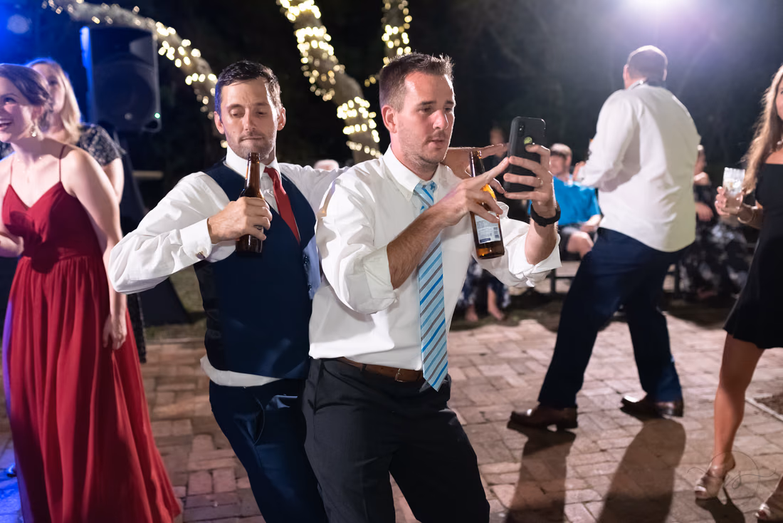 Groomsmen dancing with drinks in hand at the reception - Pelican Inn - Pawleys Island