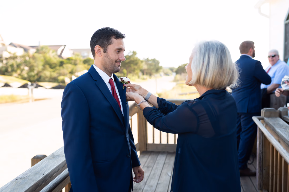 Mother helping groom with his boutonniere - Pawleys Island Chapel