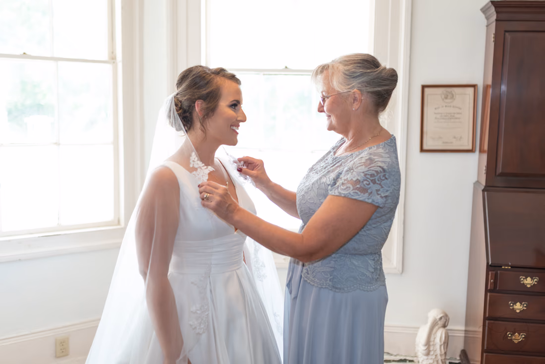 Mother pulling bride's veil over her shoulders - Pelican Inn - Pawleys Island