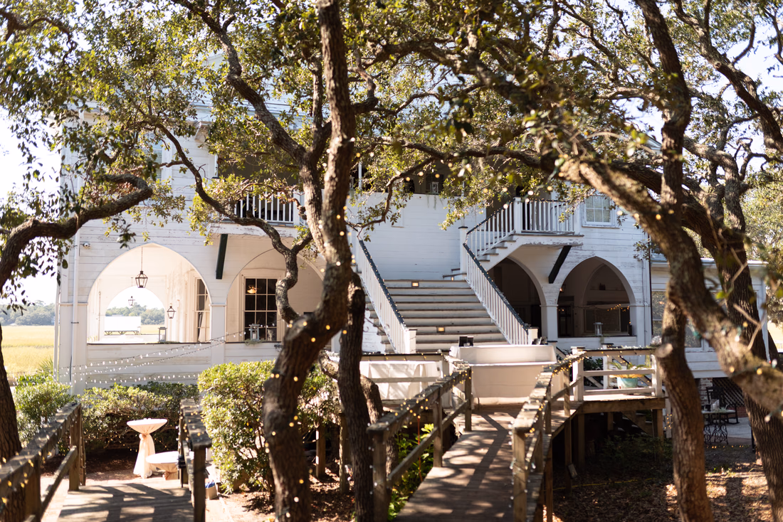 View of the Pelican Inn from the back looking through the trees - Pelican Inn - Pawleys Island