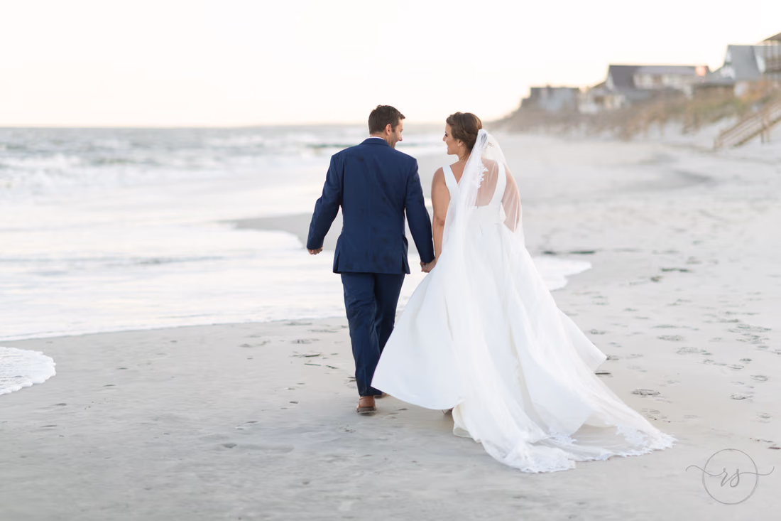 Walking down the beach holding hands - Pelican Inn - Pawleys Island