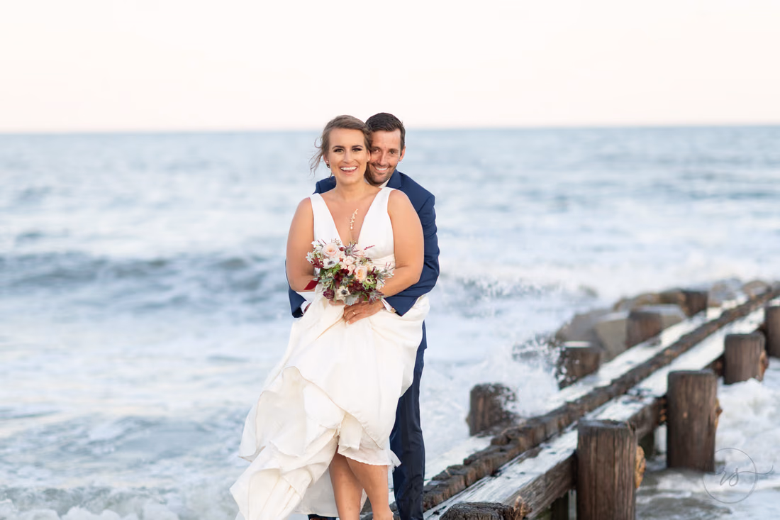 Waves crashing around the couple - Pelican Inn - Pawleys Island