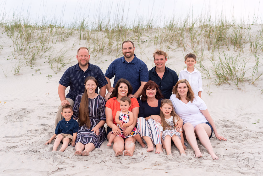 Big family sitting in front of the dunes - Huntington Beach State Park
