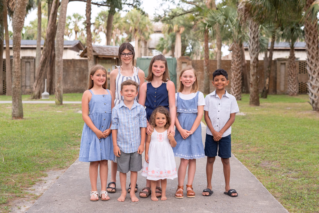 Kids standing in a row by the walls of Atalaya Castle at Huntington Beach State Park