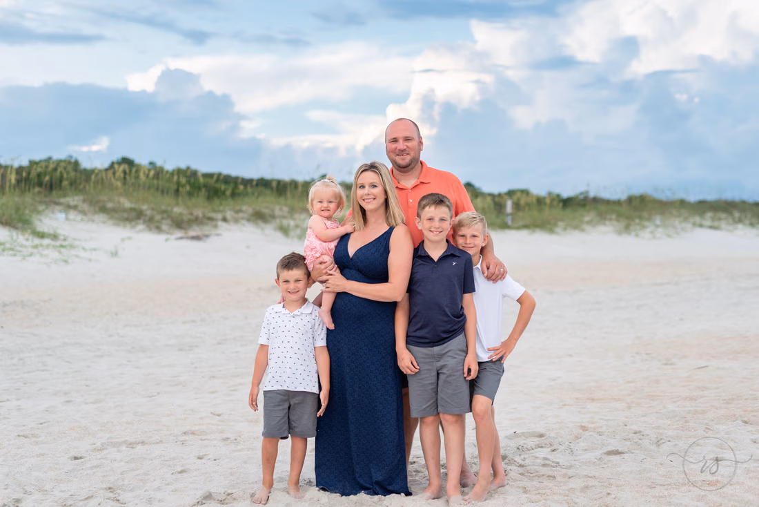 Mom, dad and their four kids in front of the dunes at Huntington Beach State Park