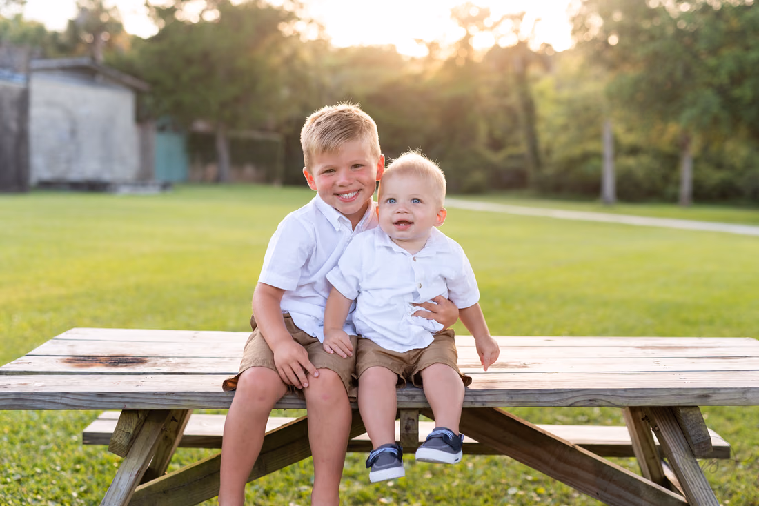 Brothers sitting together on a picnic table at Huntington Beach State Park