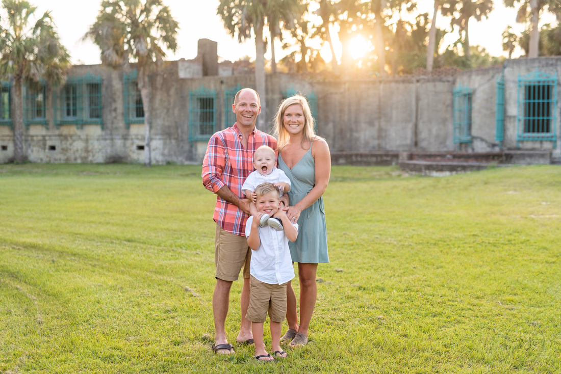 Family standing in front of Atalaya Castle at Huntington Beach State Park