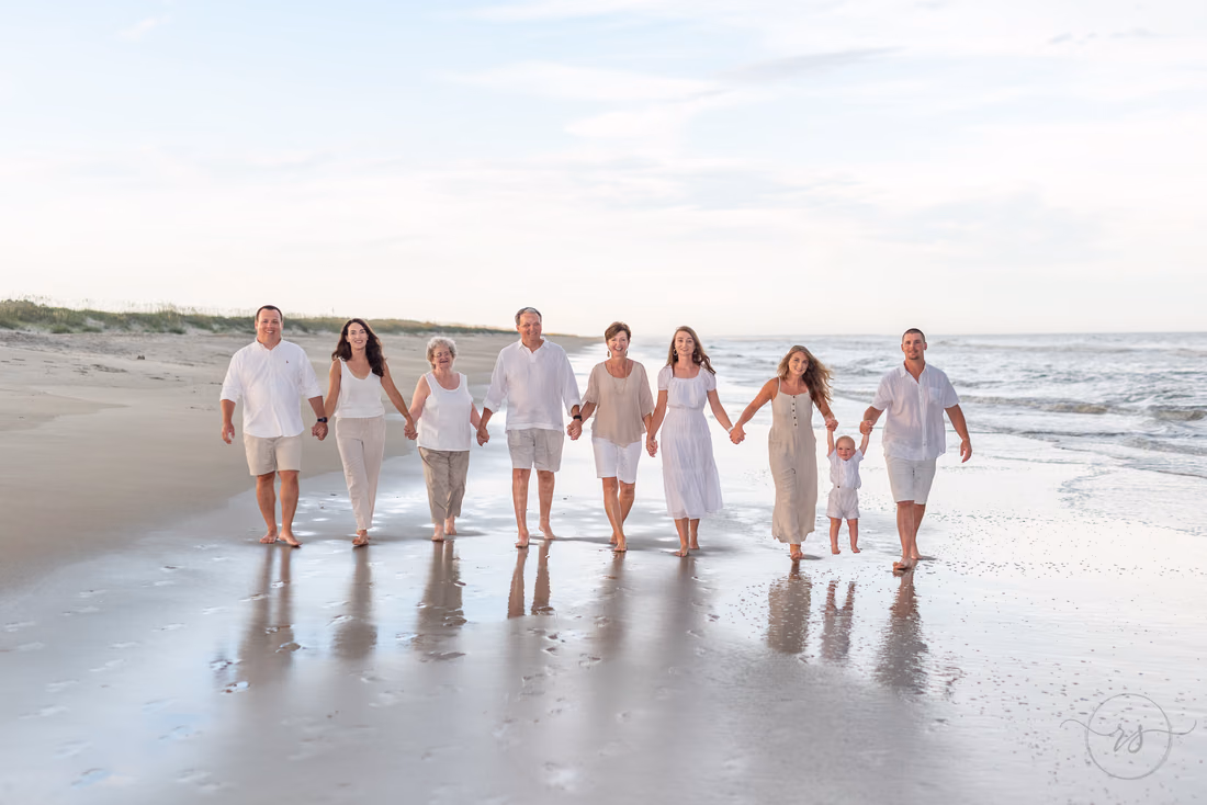 Family walking hand in hand down the beach at Huntington Beach State Park