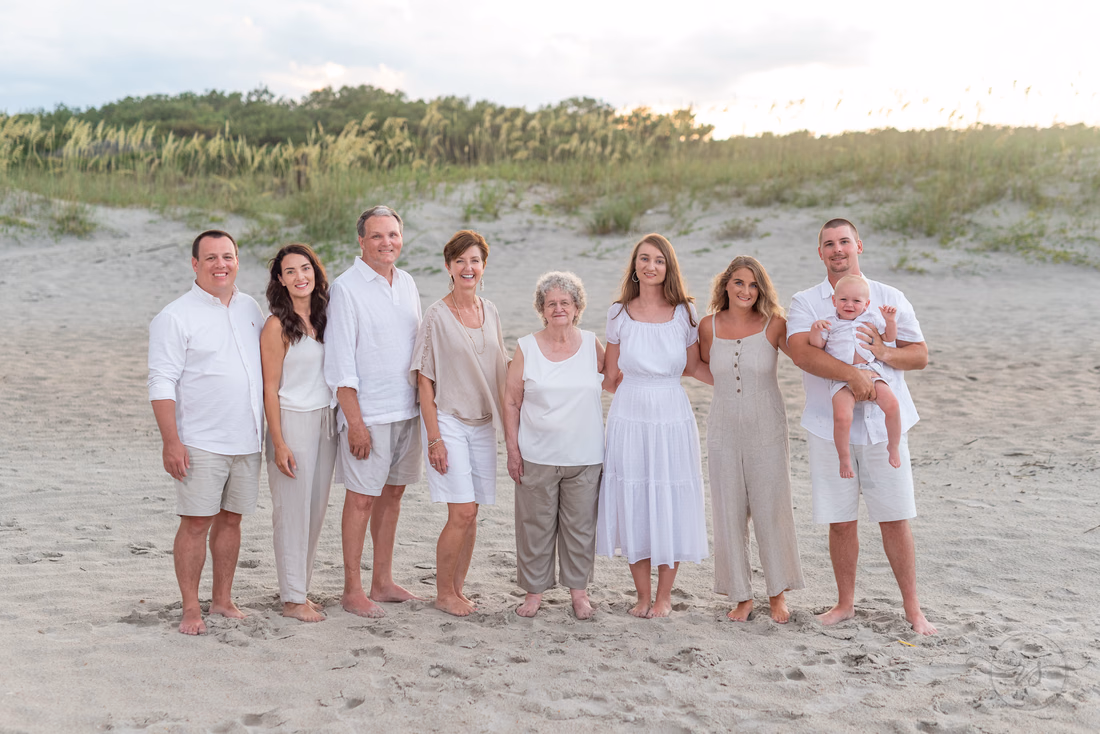 Family dressed in white standing by the dunes at Huntington Beach State Park