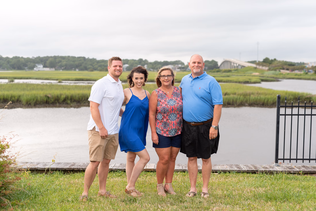 Family in front of the bridge and marsh - Ocean Isle
