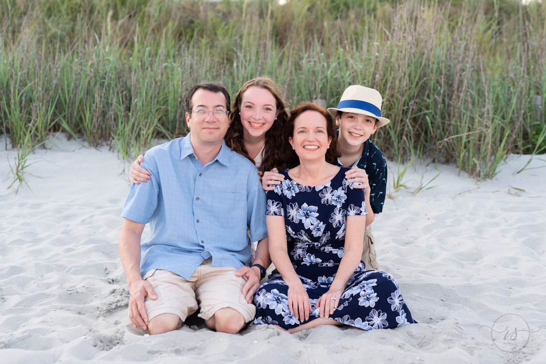 Family of four posing at their beach house in Myrtle Beach