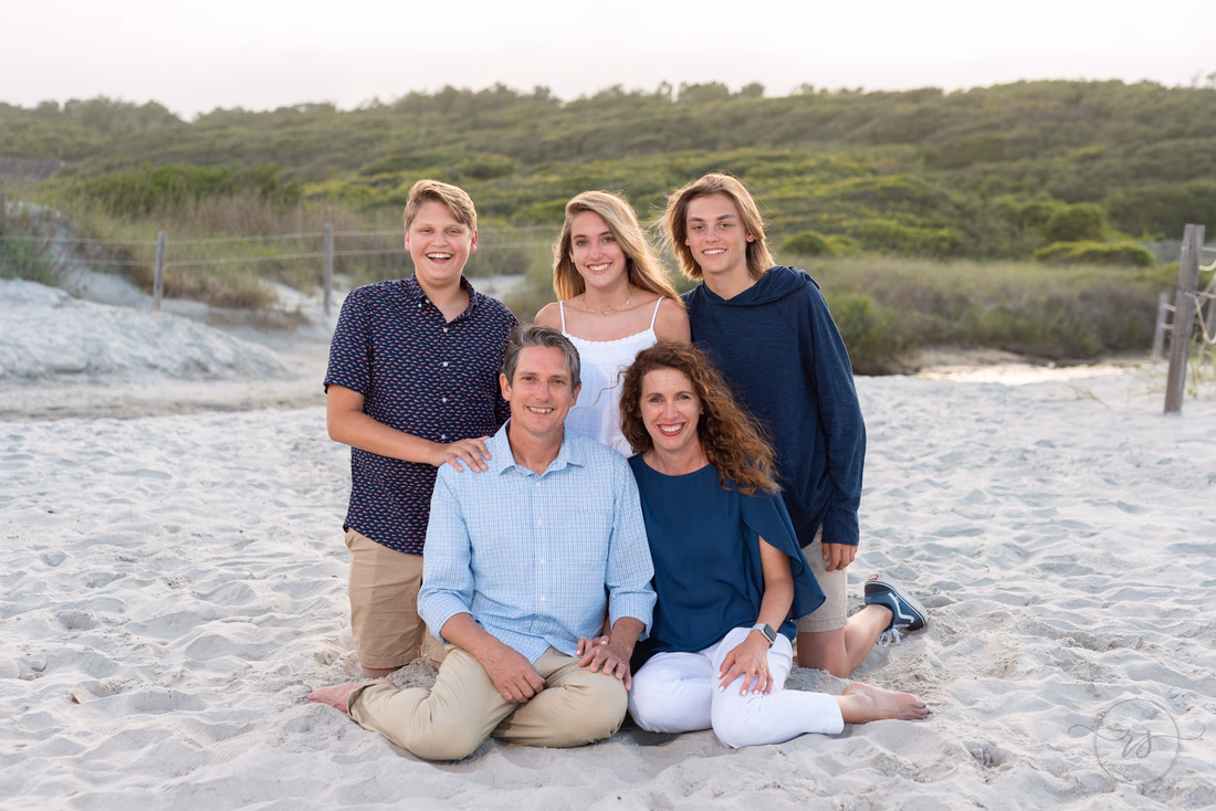 Family of five standing together by the dunes at Myrtle Beach State Park