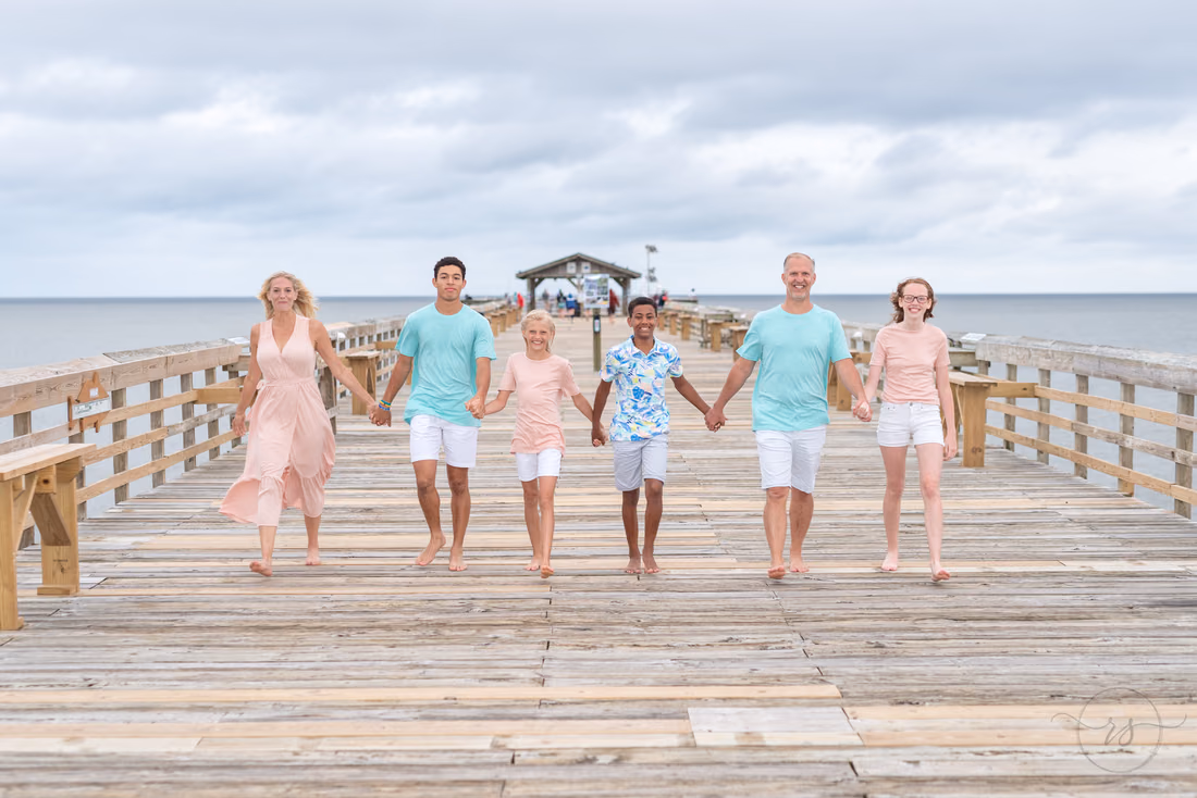 Family walking together down the pier at Myrtle Beach State Park