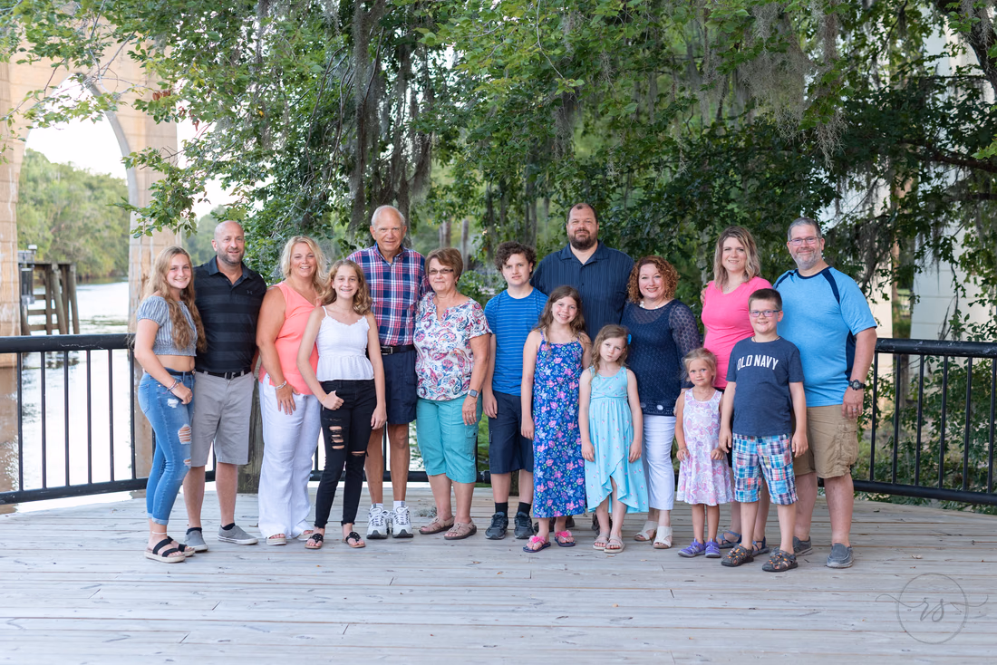 Family standing by the river - Conway Riverwalk
