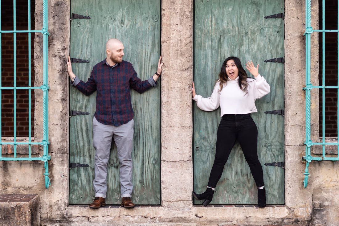 Couple having fun posing in the Atalaya Castle doors - Huntington Beach State Park