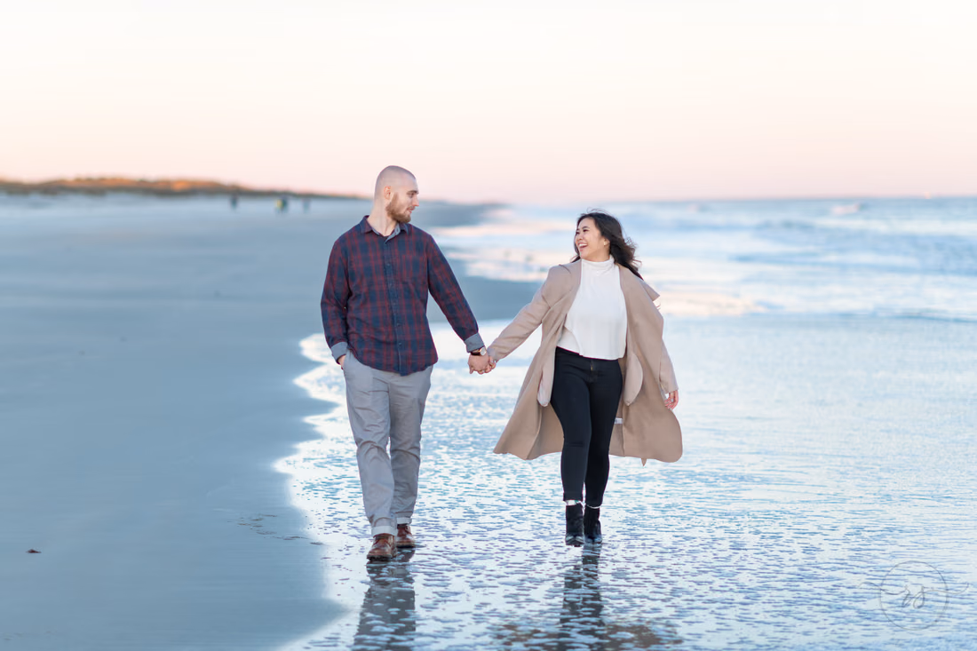 Engaged couple walking down the beach together - Huntington Beach State Park