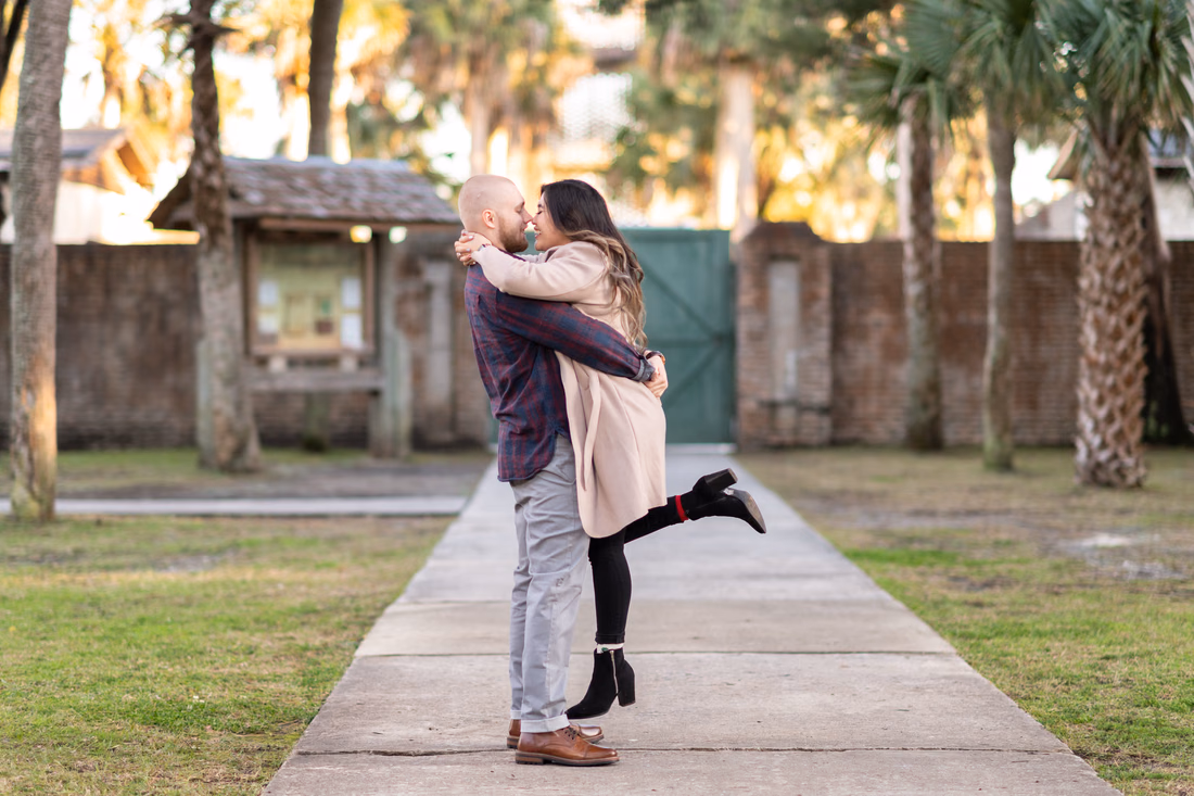 Lifting girlfriend into the air - Huntington Beach State Park