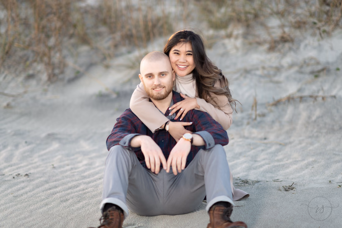 Sitting together in front of the dunes - Huntington Beach State Park