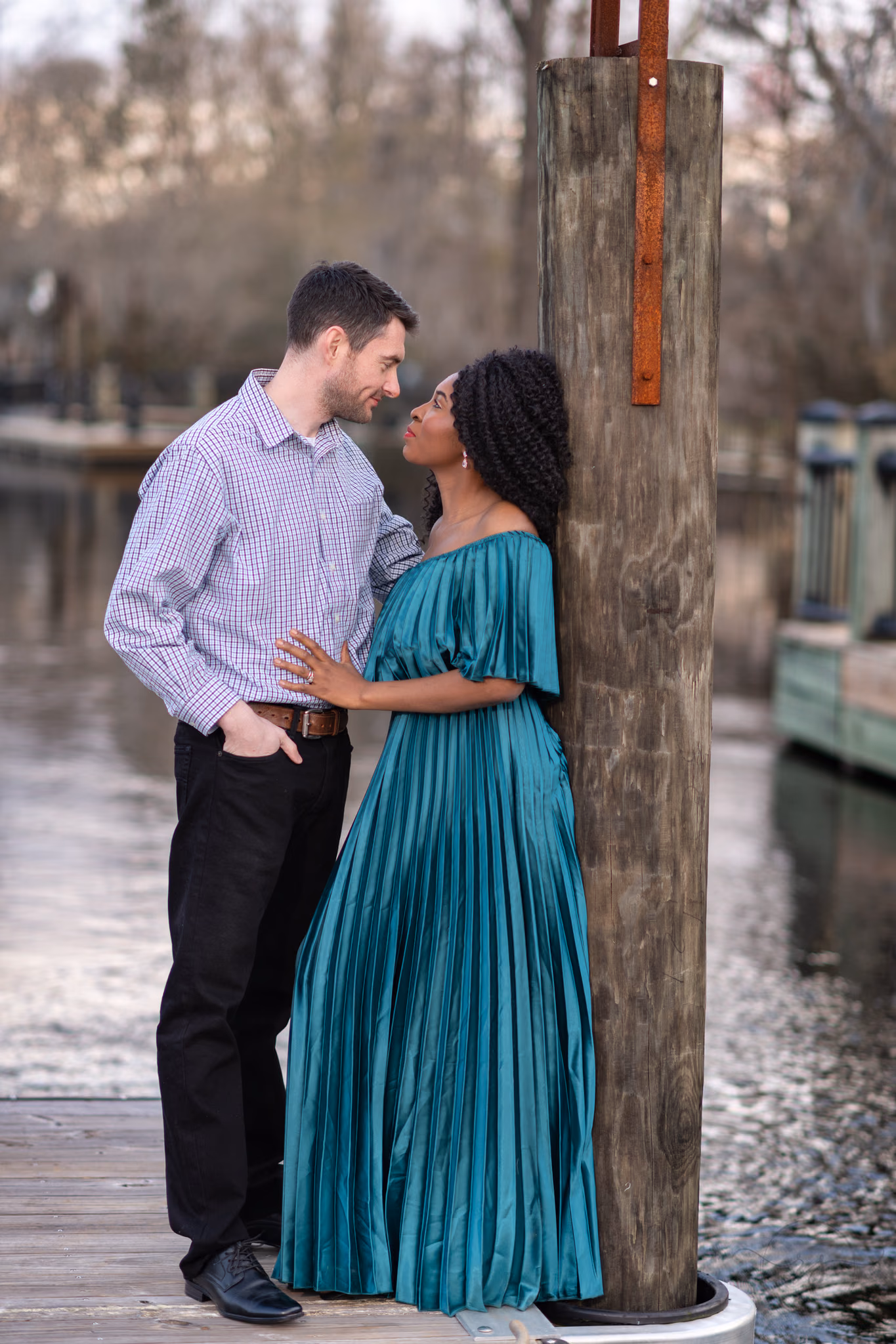 Anniversary portraits leaning against the river dock - Conway Riverwalk