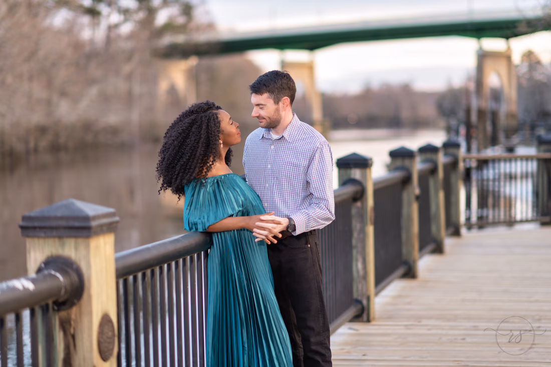 Husband and wife leaning against the boardwalk railing - Conway Riverwalk