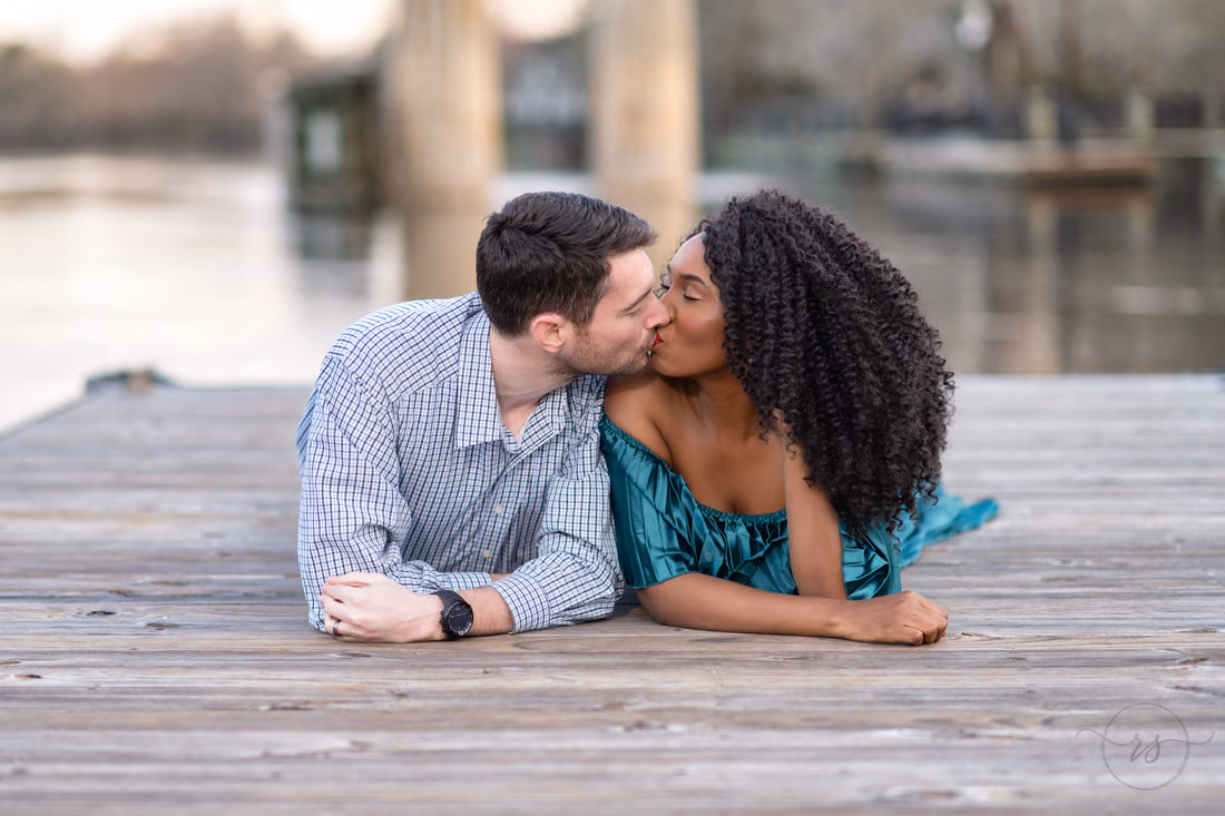 Kiss lying together on the dock - Conway Riverwalk