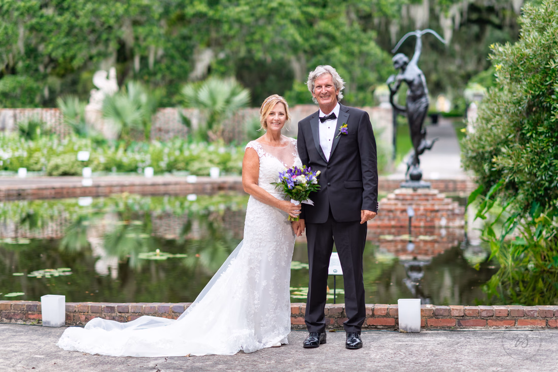 Bride and groom holding hands - Diana of the Chase Pool - Brookgreen Gardens