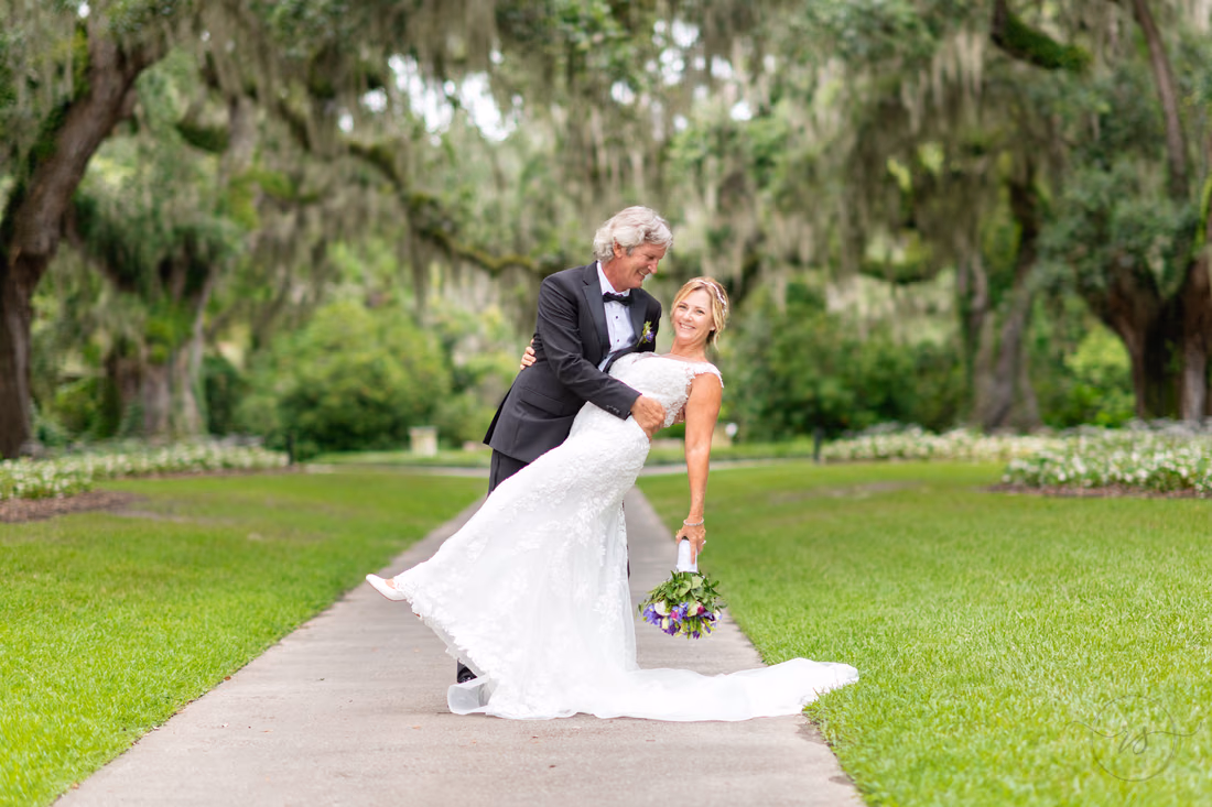 Groom dipping bride back under the oaks - Live Oak Allee - Brookgreen Gardens