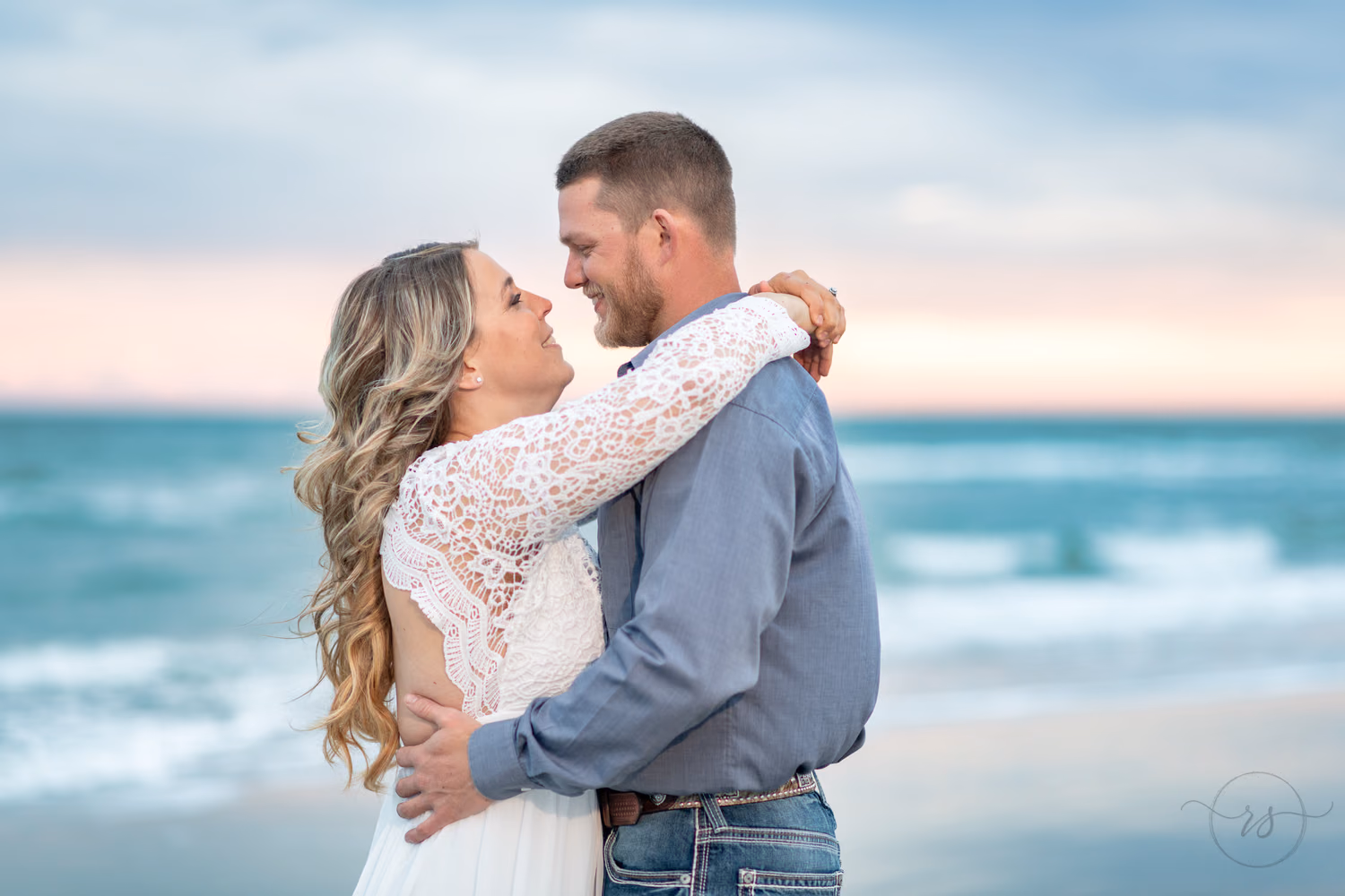 Closeup portrait of man and woman looking into each other's eyes. - Huntington Beach State Park