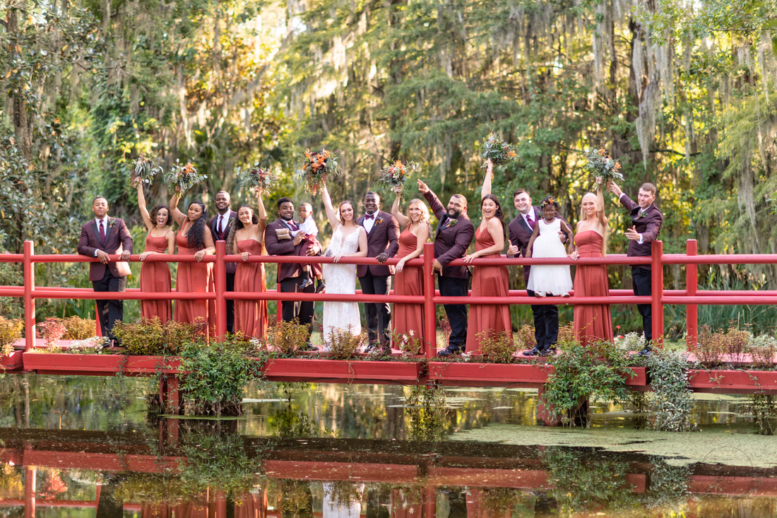Bridal party cheering on red bridge - Magnolia Plantation - Charleston, SC