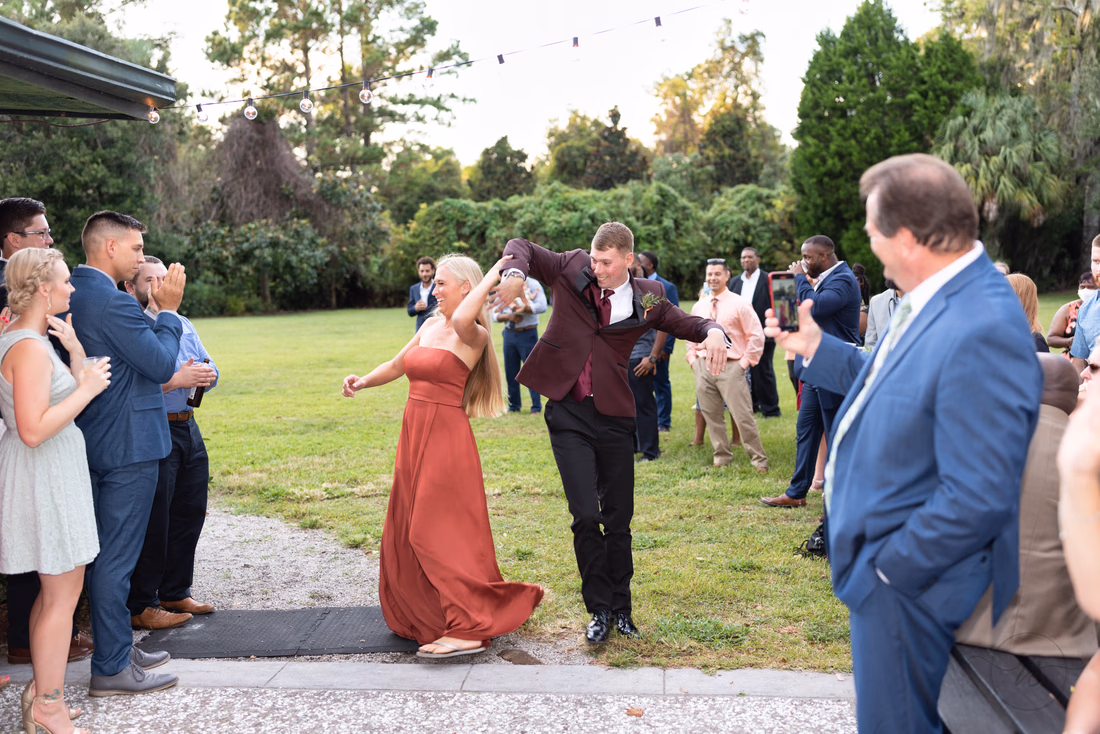 Bridesmaid and groomsman dance into the reception at Magnolia Plantation