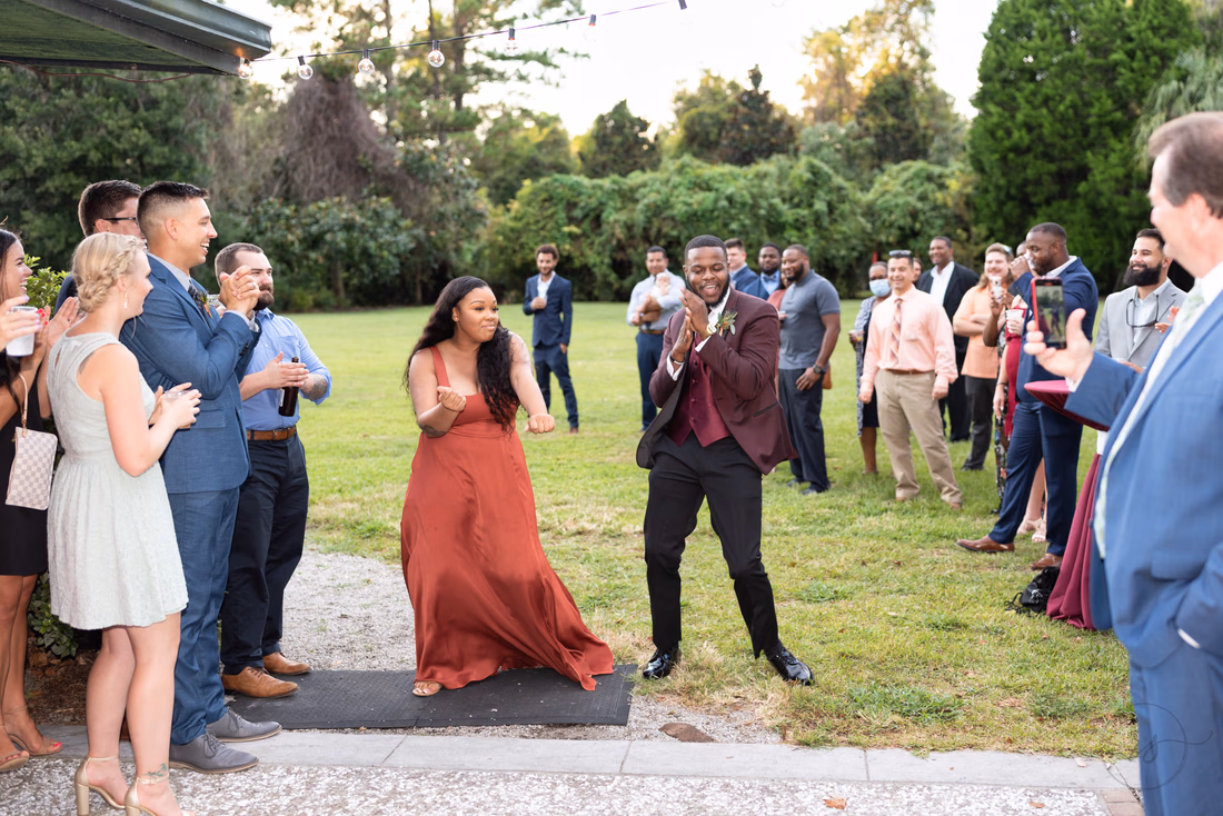 Another bridesmaid and groomsman make their entrance at the reception at Magnolia Plantation