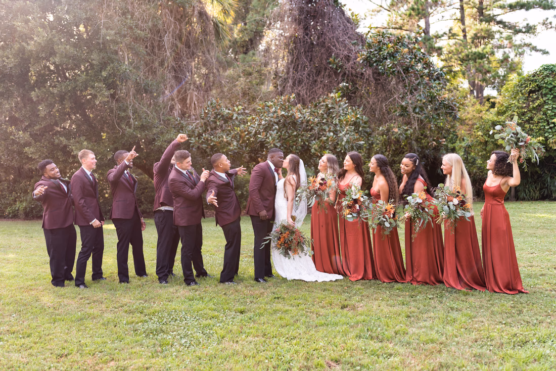 Bridal party cheering on the lawn by the Carriage House at Magnolia Plantation
