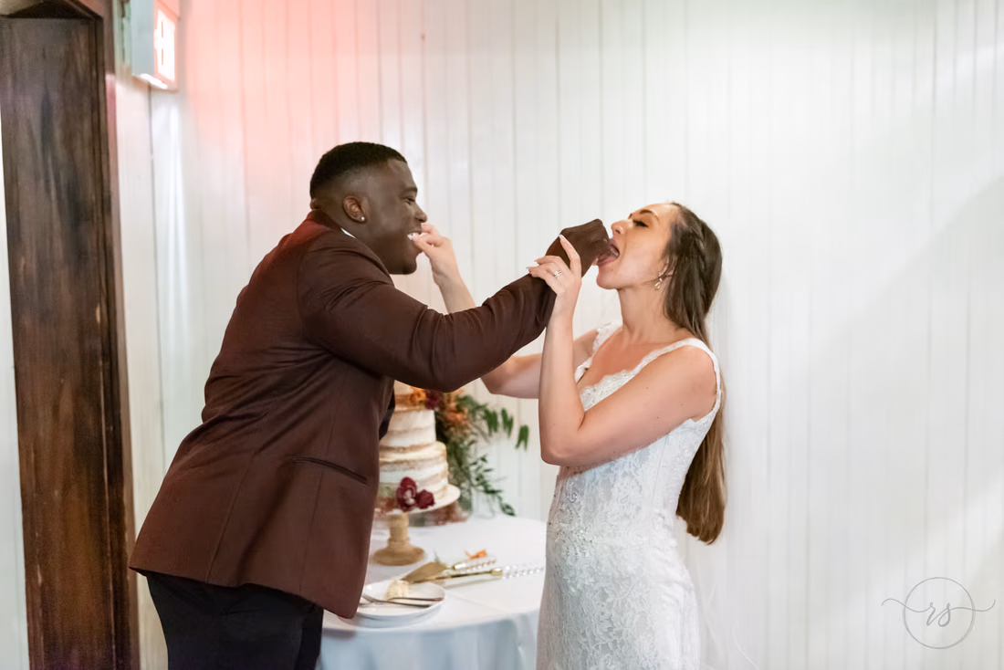 Groom feeds the bride a bite of wedding cake at Magnolia Plantation