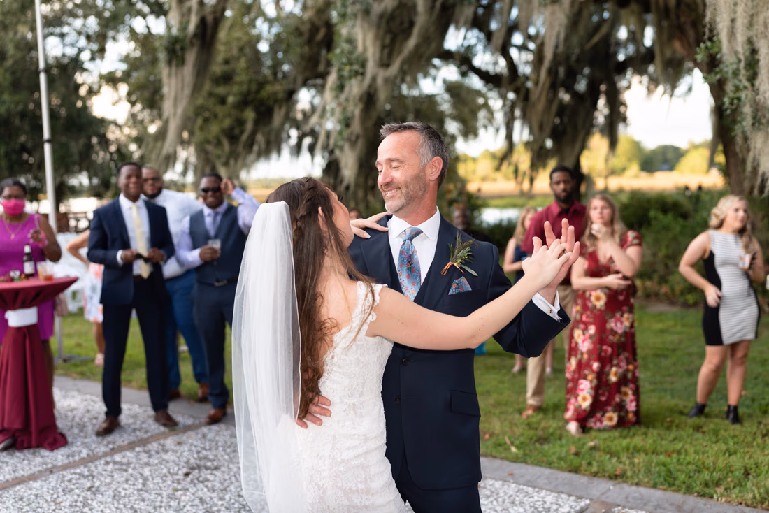 Bride and her father dance on the patio under the oaks at Magnolia Plantation