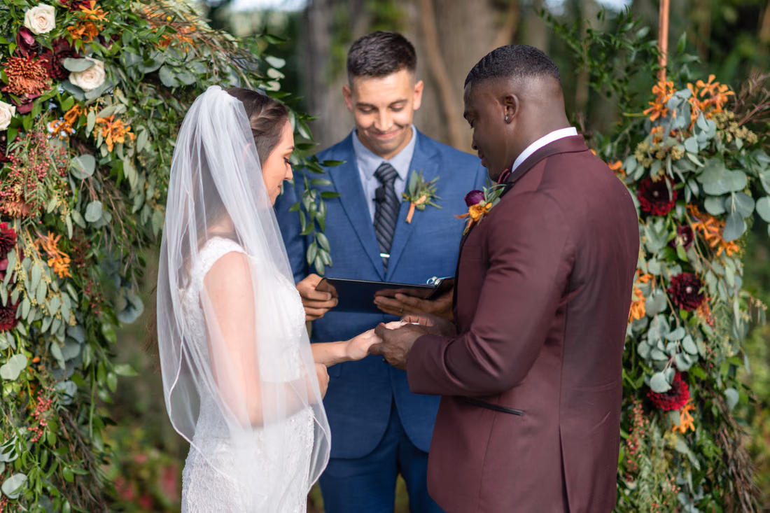 Close view of the ring exchange under the floral arch at Magnolia Plantation