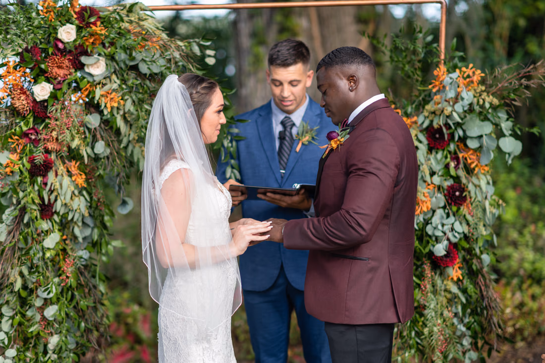 Couple exchanges rings in front of the officiant at Magnolia Plantation