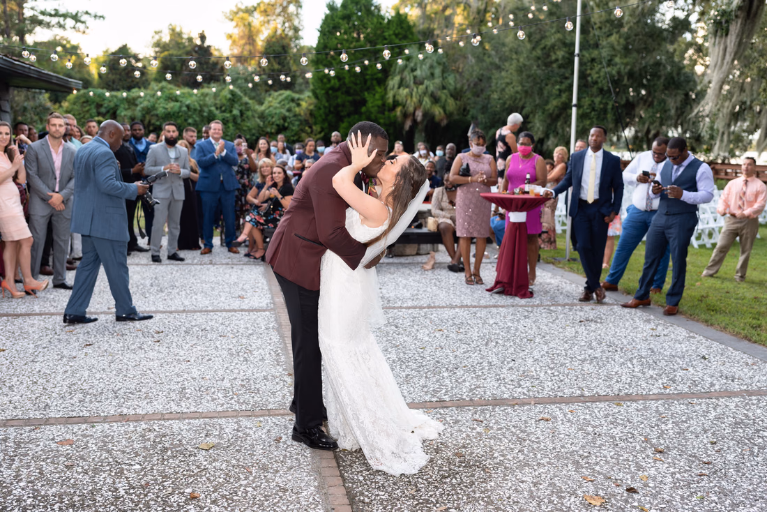 Groom kisses the bride during their first dance at Magnolia Plantation